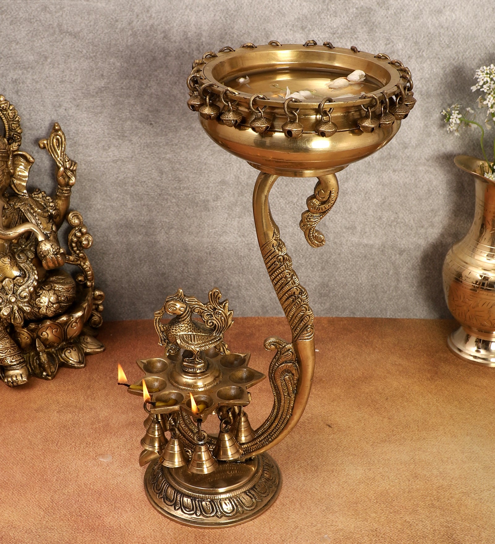 Brass 15 Inches Stand with 9 Oil Wick Peacock Diya and 6 Inches Brass Urli with Bells